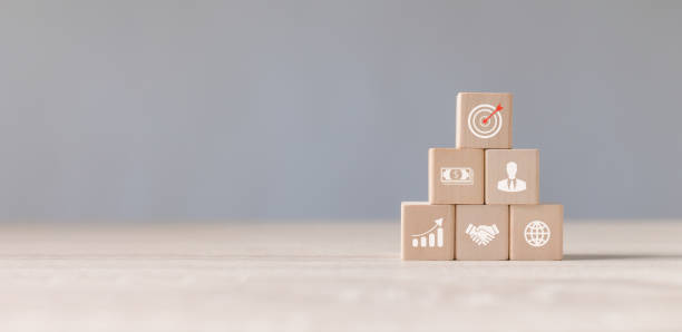 istock Wood cube block stacking with icon about business strategy and action plan. Dartboard and arrow for set up business objective target. Goal and targeting the business concept. Copy space. 1468447562