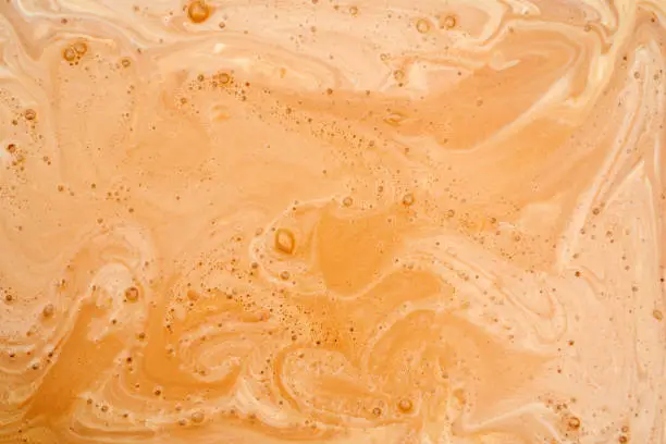 Photo of Coffee with milk texture. View from above.