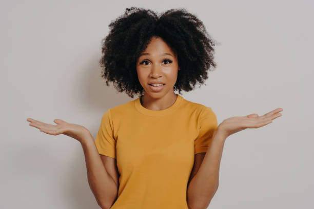 istock Confused doubtful black woman shrugging with shoulders, feeling baffled while looking at camera 1468451188