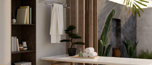 istock Copy space on white marble tabletop with bath accessories against window with tropical garden view 1468455752