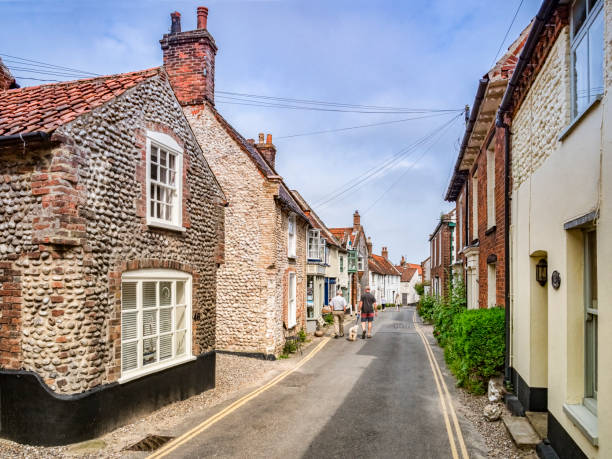 23 June 2019: Blakeney, Norfolk, UK - High Street, Blakeney, with traditional style flint buildings.