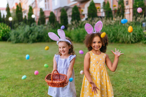 istock a happy girl juggles eggs on the lawn during Easter hunting 1468457399
