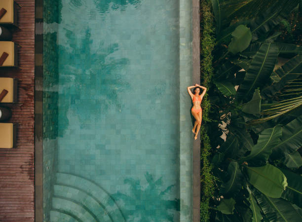 istock Young woman lying on the poolside 1468459215