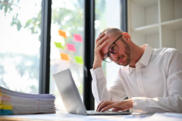 istock Stressed and thoughtful Caucasian businessman having some problems on his project 1468459695