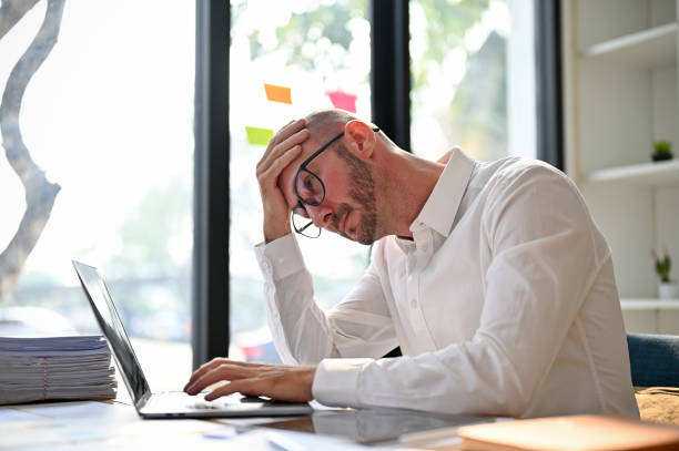 istock Stressed and unhappy caucasian businessman having problems on his business, using laptop 1468459697