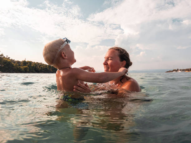 istock Loving Caucasian Mother Spending Quality Time With Her Son While On Vacations At The Beach 1468460922
