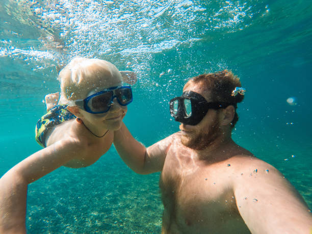 istock Caring Father Playing With His Small Boy Underwater 1468462573