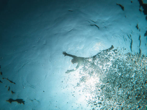 istock Shadow Of A Kid Floating In Water 1468462584