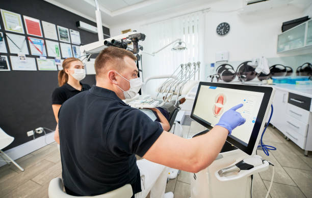 istock Dentist scanning patient's teeth with modern machine for intraoral scanning. 1468463140