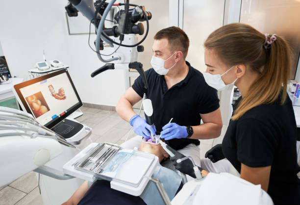Dentist scanning patient's teeth with modern machine for intraoral scanning. stock photo