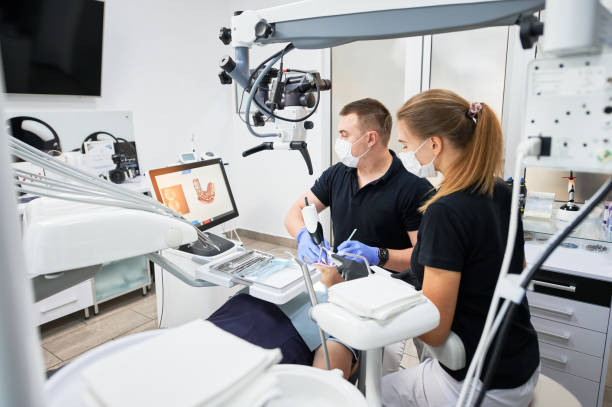 istock Dentist scanning patient's teeth with modern machine for intraoral scanning. 1468463186