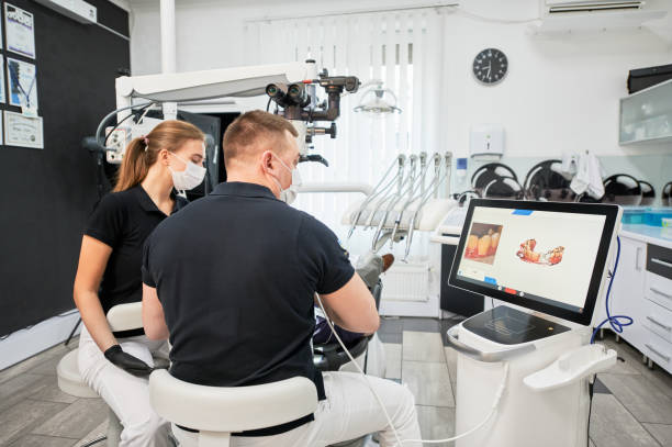 istock Dentist scanning patient's teeth with modern machine for intraoral scanning. 1468463208