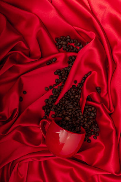 Cup of coffee on red silk background