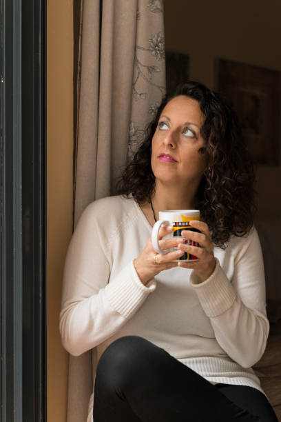 istock A woman with a cup in her hands. 1468466131