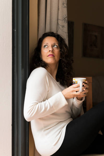 istock A woman with a cup in her hands. 1468466168