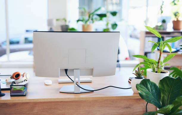 Computer, technology and office of empty table in workspace building. Backgrounds, business and desktop monitor in workplace, company and job room of modern interior design in startup agency