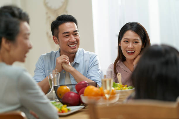 istock asian family chatting while eating meal 1468466931