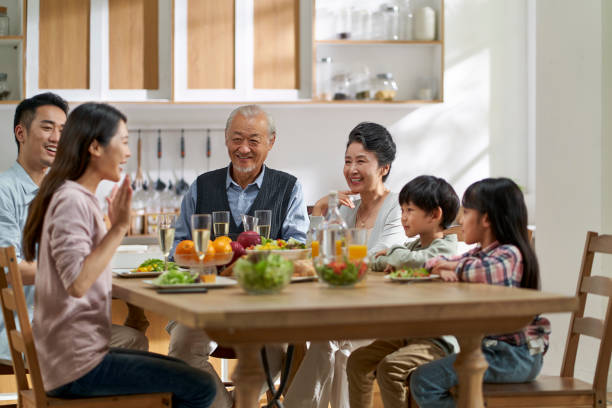 istock asian family chatting while eating meal 1468466932