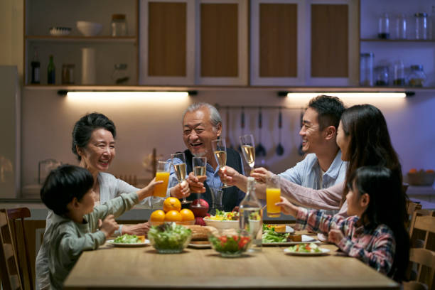 istock three generation asian family toasting while having dinner together 1468466957