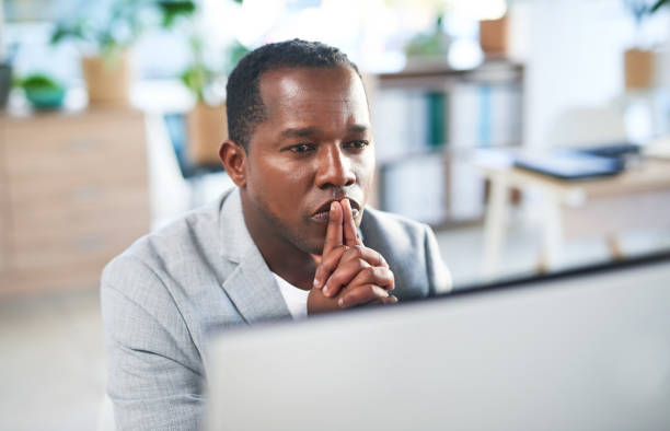 istock Office computer, thinking or black man review finance portfolio feedback, stock market database or investment budget. Serious forex manager, data analysis idea or trader trading NFT or bitcoin crypto 1468467041