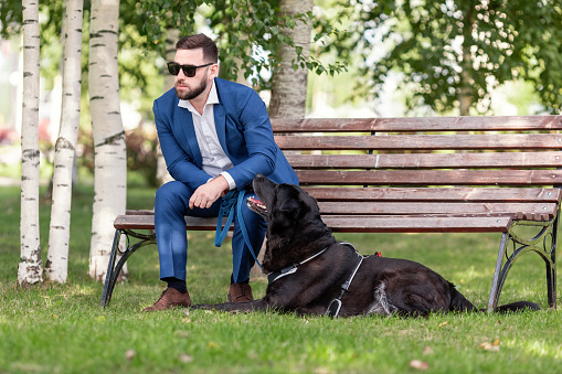 Businessman with dog in park