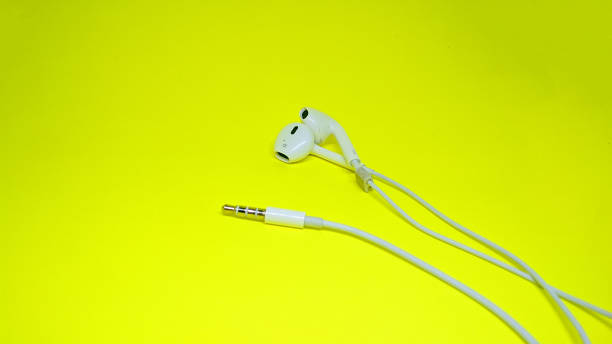 istock White earphones on a yellow background, copy space. 1468471054