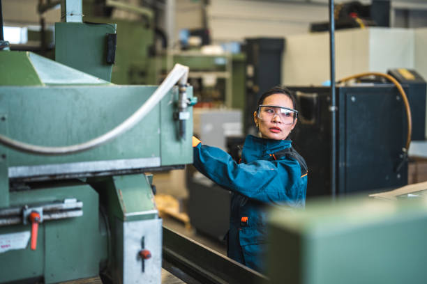 istock Mid Adut Asian Female Factory Worker Operating A Machine 1468471928