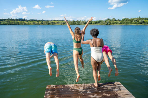 istock Friends jumping in lake 1468472692
