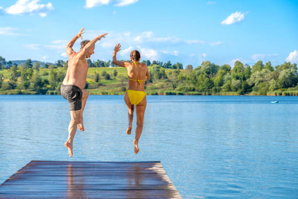 istock Couple jumping in lake 1468472791