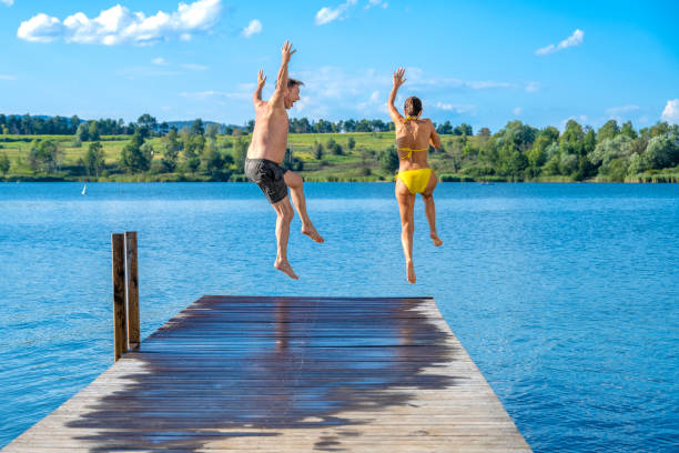 istock Couple jumping in lake 1468473315
