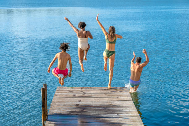 istock Friends jumping in lake 1468473344
