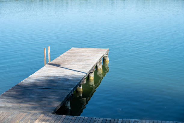 Wooden pier on blue water lake.