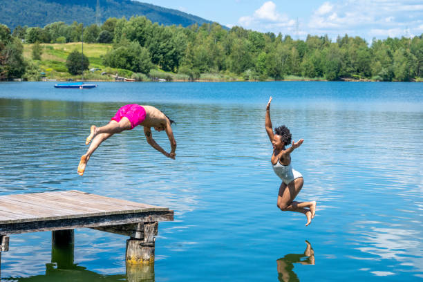 istock Couple jumping in lake 1468473733