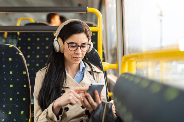 istock Woman using mobile phone at the public transport 1468478698