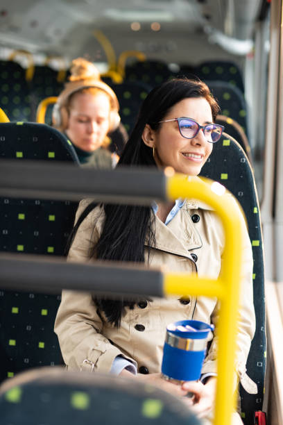 istock Young woman sitting in bus and looking through the window 1468478731