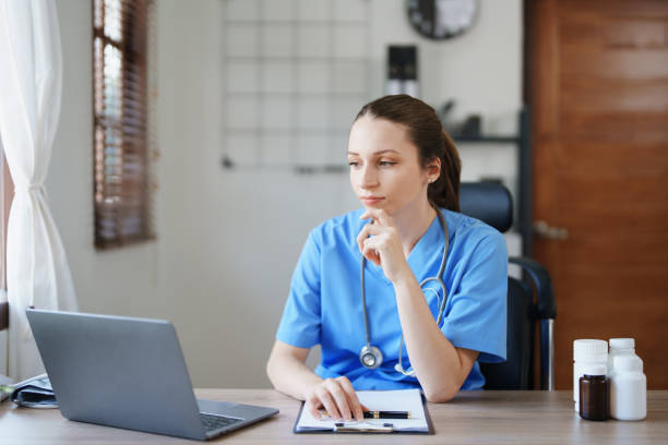 istock Portrait of a female doctor using a computer and a document analyzing a patient's condition before treating. 1468478766
