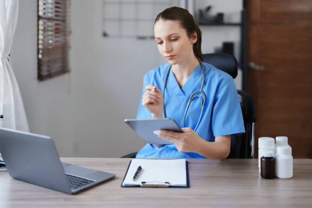 istock Portrait of a female doctor using a tablet computer and a document analyzing a patient's condition before treating. 1468478933