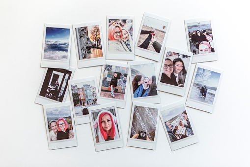 Travel memories concept - Instant photos from a trip on the table