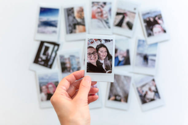 istock Woman holding instant photos from a trip 1468482259