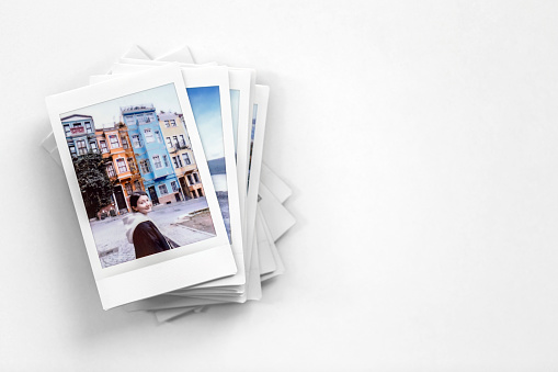 Stack of retro polaroid photos from a trip with copy space - Travel memories concept