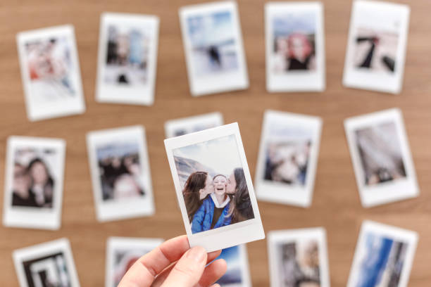 istock Woman holding instant photos from a trip 1468482579