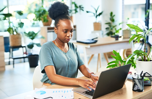 Accountant, laptop typing and business woman review financial savings, finance budget or accounting compliance. Analytics, bookkeeping data analysis or African administration work on research graph