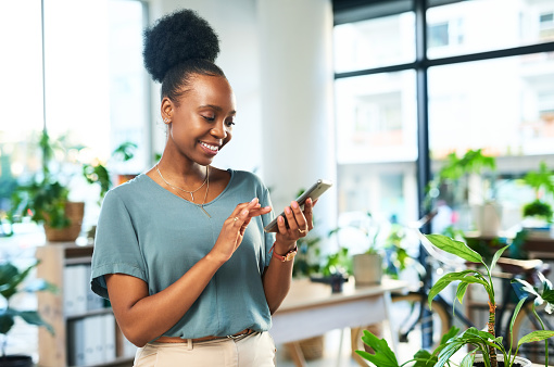 Black woman, phone and typing in office for contact, data management app and reading business notification. Happy female worker, smartphone and mobile connection for networking, technology and media