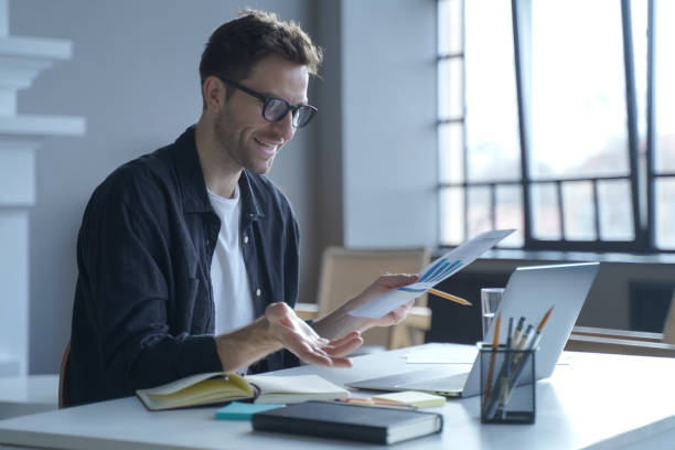 istock Young German businessman in glasses discussing calculation chart reports with partners online 1468485169