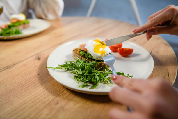 istock Close-up of a poached egg sandwich on a white plate. 1468485484