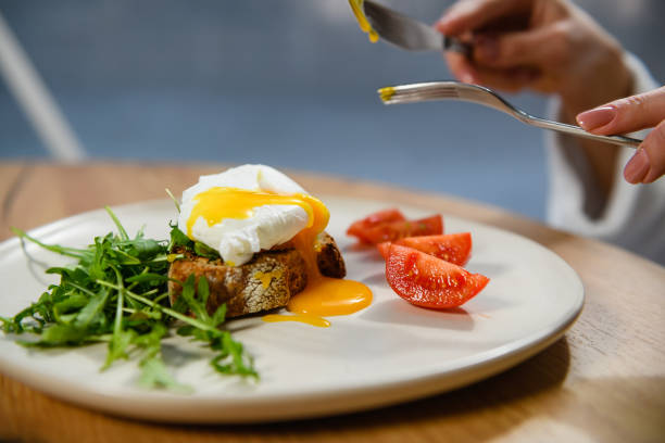 istock Close-up of a poached egg sandwich on a white plate. 1468485492