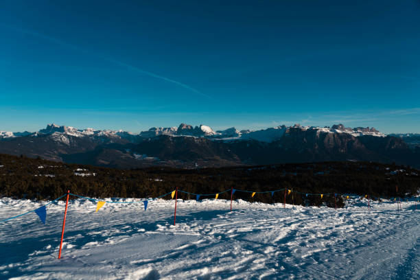 Snow, colored flags and breathtaking views. Snowy Dolomites in winter.