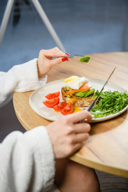istock Close-up of a poached egg sandwich on a white plate. 1468485522
