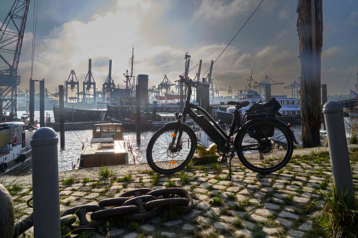 Hamburg, Germany, November 14, 2022: The bicycle is a mode of transportation in the bustling port city of Hamburg, with built structures against its clear sky and fluffy clouds.