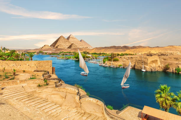 Sailboats and ancient rocks in the Nile on the way to pyramids, Aswan, Egypt stock photo